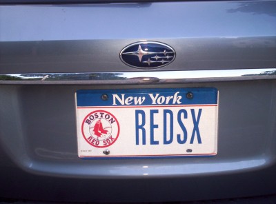 A Red Sox-branded New York vanity license plate with the letters REDSX on it; riddle me that, Batman