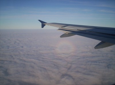 The glory just beneath the furthest hydraulic motor on the wing, with a brilliant blue sky above