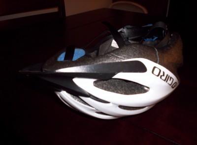 A used bike helmet on a table with a visible crack in it