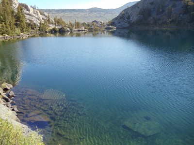 Looking across the eastern expanse of Garnet Lake toward its outlet, crossed by a barely-visible wooden bridge Looking across the eastern expanse of Garnet Lake toward its outlet, crossed by a barely-visible wooden bridge