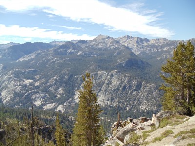 Mountains in the distance after an evergreen-covered valley just below